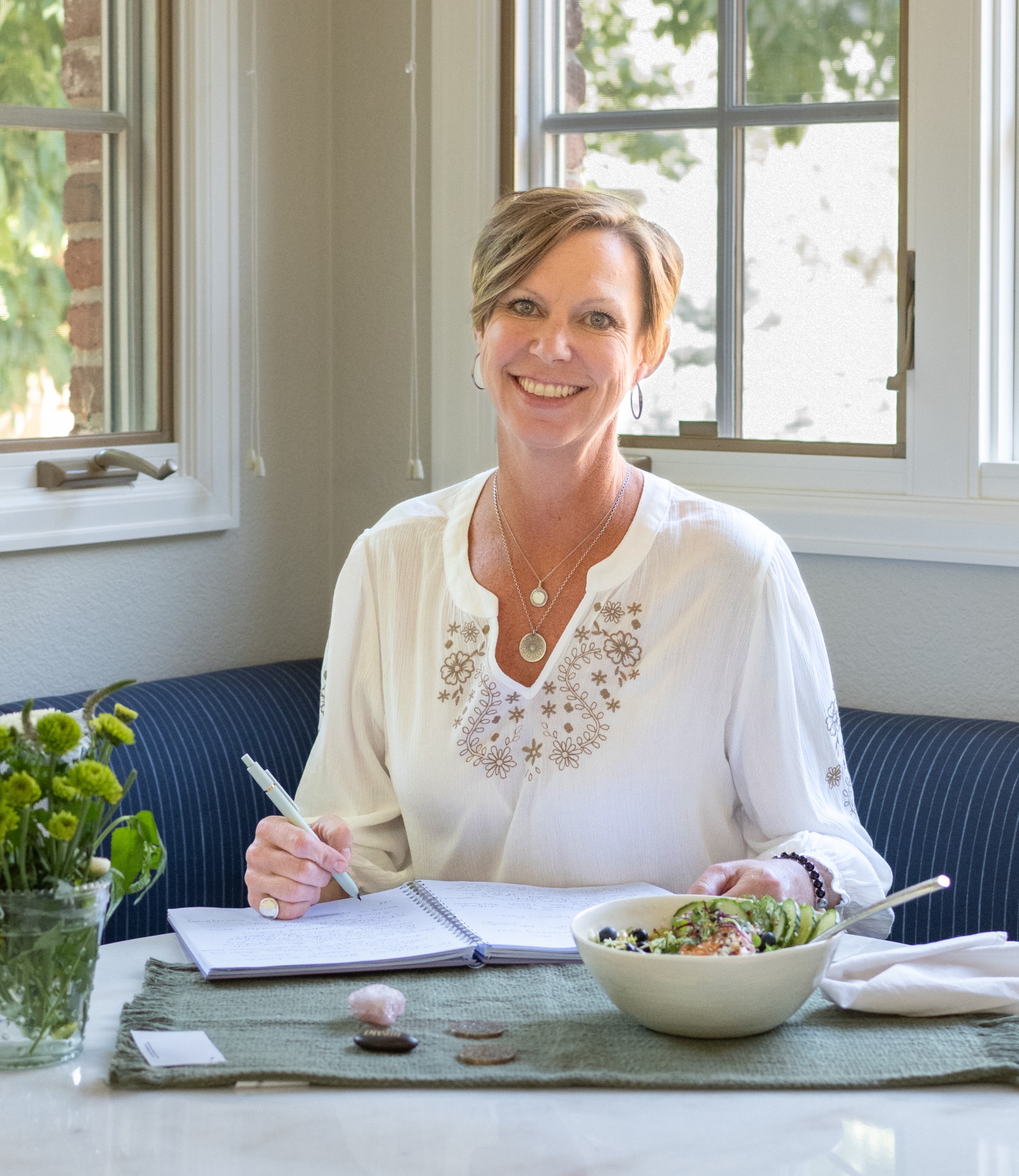 Heather Axtell, founder and Soul Chef of Pure Joy Soul Bowls, journaling beside a Soul Bowl